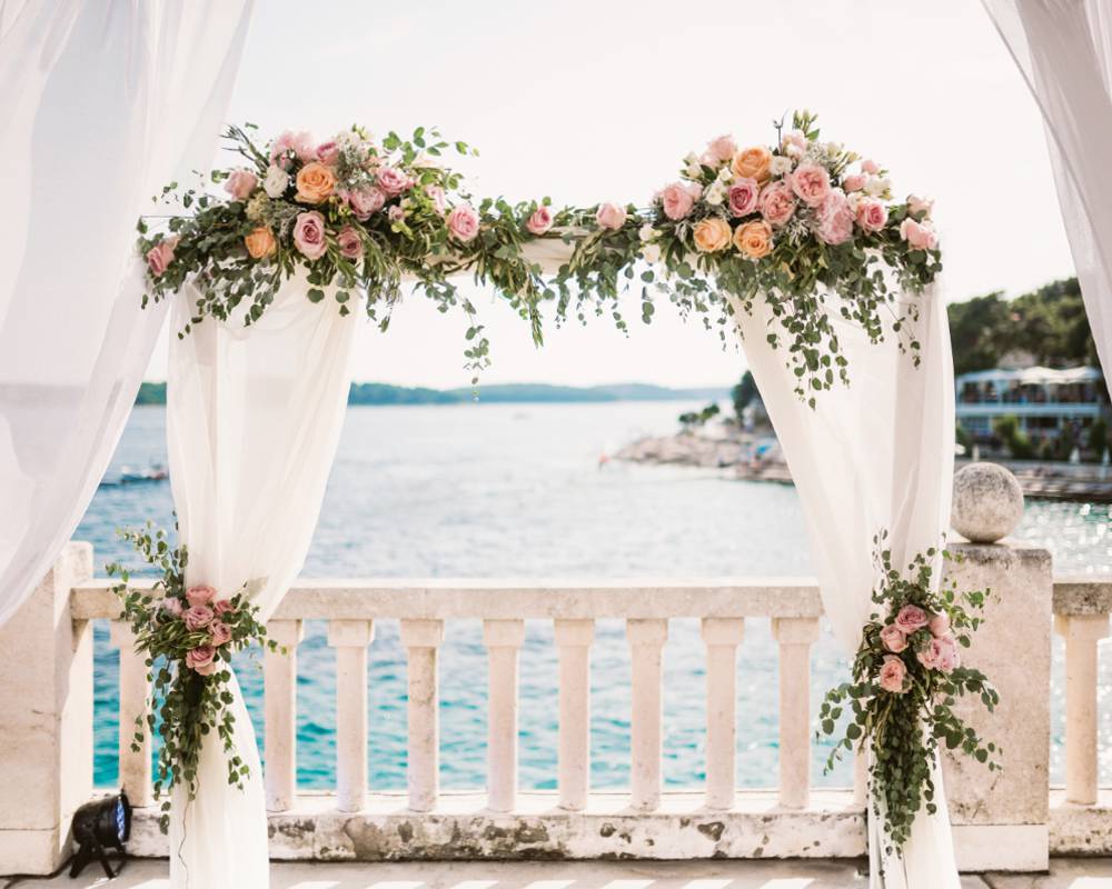 arch with flowers decor by the sea in Sardinia